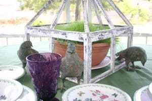 This bird is trying to hide behind the pretty purple glass.