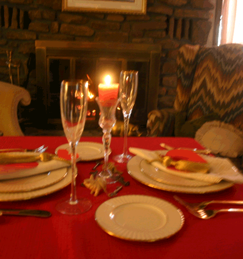 A cozy table in front of the fireplace.