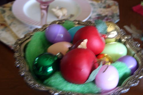 A centerpiece with Easter eggs, Christmas ornaments and . . . apples!